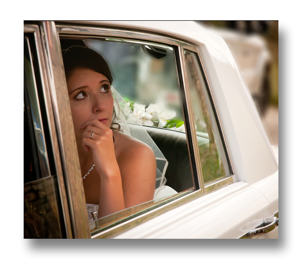 bride in wedding car looking out